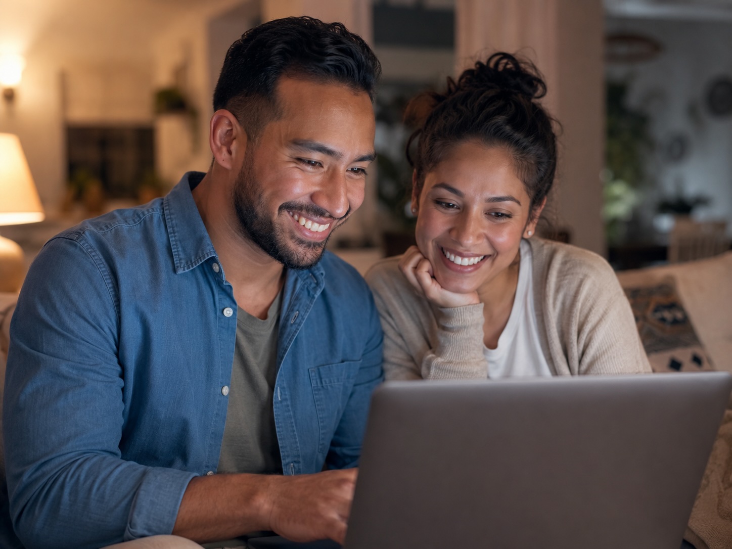 Latino couple at home making a confident financial decision together online