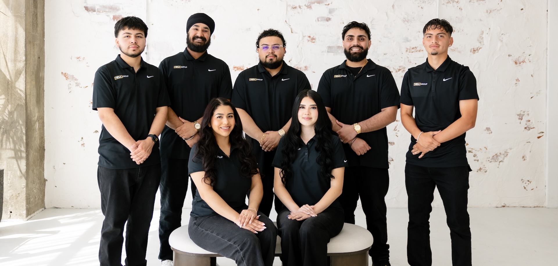 Mesa Group Consulting leadership team in formal black uniforms
