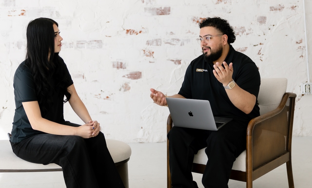 Evert Calderon of Mesa Group Consulting standing with an open MacBook